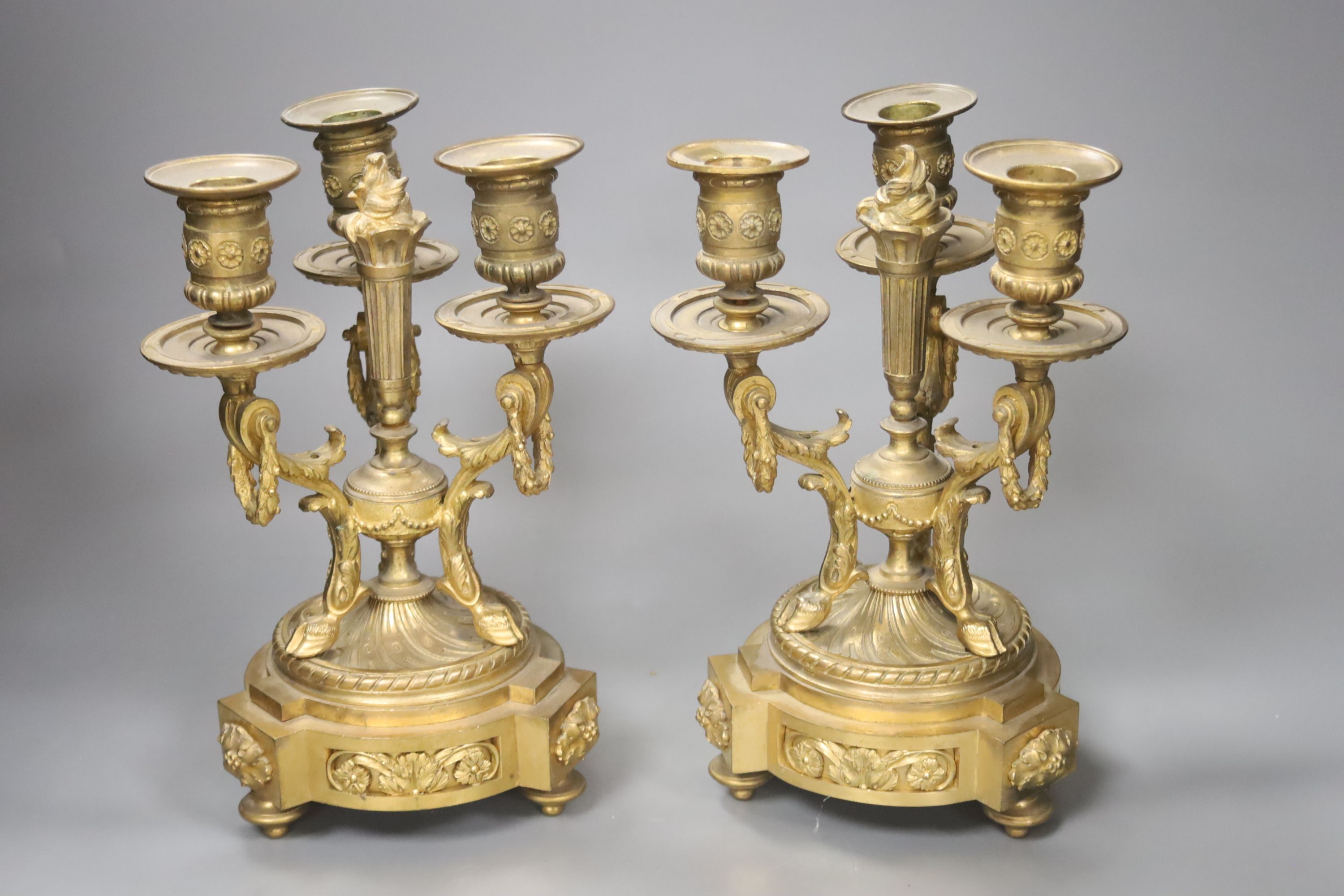 A pair of ormolu three branch candelabra